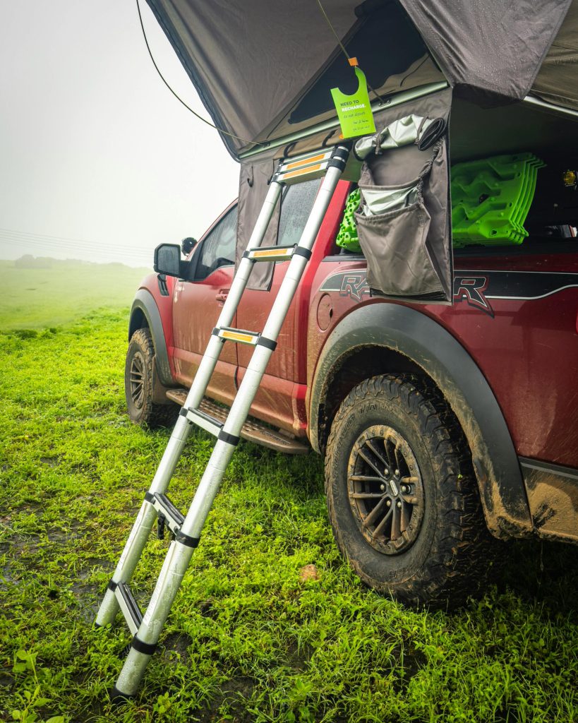 Red off-road pickup with a roof tent Camping gear Rwanda